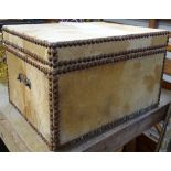 An Antique cowhide covered box with brass handles, 40cm across