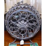 A barrel design wrought-iron wine rack