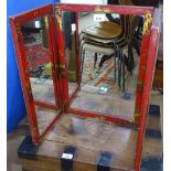 An Oriental red lacquered and chinoiserie decorated 3-fold dressing table mirror