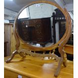 An Edwardian mahogany oval swing toilet mirror