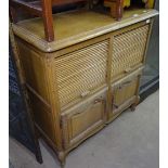 A French light oak cabinet, with 2 tambour slides and cupboards under, on cabriole legs, W102cm,