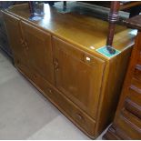 An Ercol elm sideboard, fitted with drawers and cupboards, W130cm, H76cm