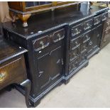 An oak Jacobean style break-front dresser base, with 6 short fitted drawers and panelled