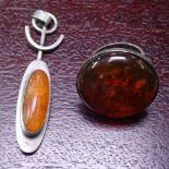 A stylised amber and silver pendant, and a silver and amber ring