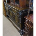 A 1920s oak sideboard, with raised panelled back, drawers and cupboards under, on melon carved legs,