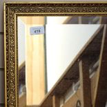 A bevelled-edge wall mirror in embossed gilt frame, length 70cm