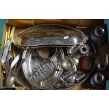 A box containing a silver plated oval galleried tea tray, a chamber stick, cutlery etc