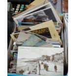 A box of loose postcards, including Hastings and St Leonards