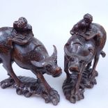 A pair of Oriental carved wood water buffalo with riders, with silver inlay decoration, height 23.