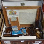 A suitcase with framed World War II message, bookends, clamps etc