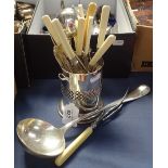 A large silver plated ladle, ivorine-handled cutlery with silver collars, bottle stand etc
