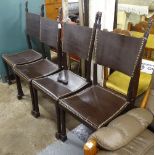 A set of 4 African Tribal design dining chairs, with figural finials, and studded leather seats