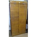 A 1930s oak double-fronted tambour filing cabinet, W83cm, H177cm