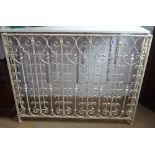 A painted wrought-iron radiator cover, L123cm, H95cm, D17cm