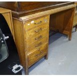 A 1930s M.O.D. oak single pedestal desk with 5 drawers, L121cm