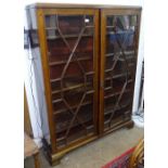 An Edwardian mahogany bookcase, with 2 lattice-glazed doors and adjustable shelves, on ogee
