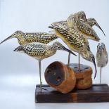 A group of carved wood wading birds on plinth, height 35cm