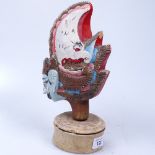 A carved and painted Eastern Thai Wayang Golek puppet's head on stand, 25cm overall