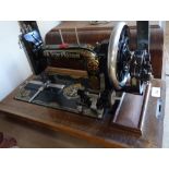 A Frister & Rossmann sewing machine in wooden case