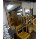 A pair of large pine-framed lead-light decorated wall mirrors, a pine chevel mirror with base, and