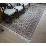 A large cream and blue ground Persian design carpet, with symmetrical pattern, L275cm x 190cm