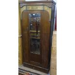 An Art Nouveau oak single mirror door wardrobe, with stylised inlaid decoration, W90cm