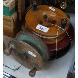 A wooden fishing reel with brass mounts, 19.5cm, and 2 smaller wooden reels