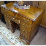 A 19th century mahogany knee-hole writing desk in Queen Anne style, with 7 fitted drawers and