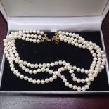 A triple-strand pearl choker necklace, with 9ct gold clasp