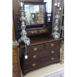 An Arts and Crafts Maple & Co oak dressing table of cantered form, with swing mirror, 2 short and