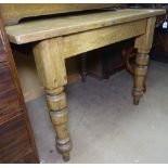 A Vintage pine plank-top kitchen table, with baluster legs