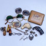 Vintage walking stick handles, sunglasses, a snuff box, and other interesting items