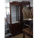 A modern mahogany shop display cabinet, with glazed door to the top and cupboards under, on