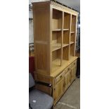 A modern limed-oak effect 2-section display cabinet, base fitted with drawers and cupboards, on