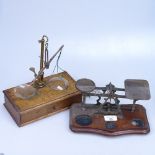 An oak scale with weights in drawer, and a small postal scale, length 24cm