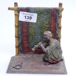 A painted spelter study of an Eastern snake charmer, height 12cm