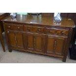 An Ercol elm sideboard, with 3 frieze drawers and panelled cupboards under, on stile legs, L145cm,