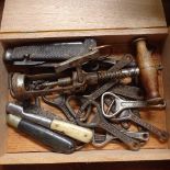 A corkscrew, pocket knives, and advertising bottle openers