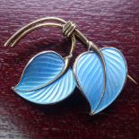 A Norwegian sterling silver gilt and blue enamel leaf brooch by Hans Myhre, Oslo