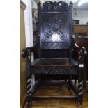 An Antique carved and panelled oak Wainscot chair, on spiral turned legs