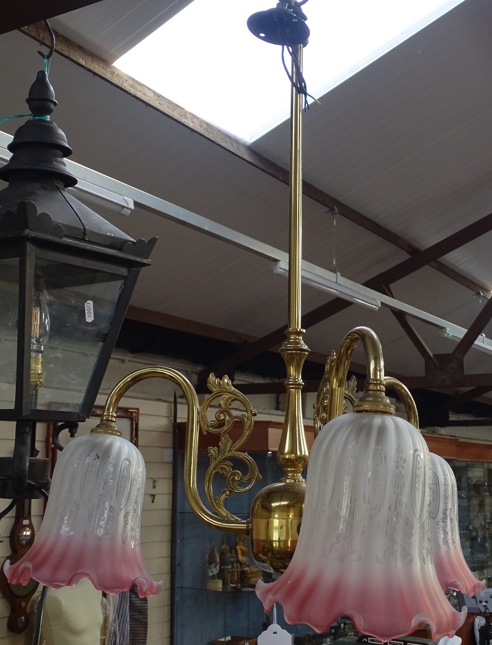 A brass 3-branch ceiling light with glass shades, 48cm across