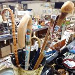 2 alpenstocks, walking sticks, in a painted metal umbrella stand with floral decoration