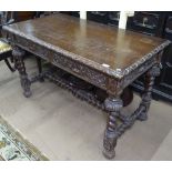 A 1920s centre-standing carved oak writing desk, with 2 frieze drawers, raised on barley twist