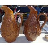 2 similar French salt glazed stoneware jugs, 1 with raised relief grapevine designs, 1 with text,