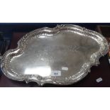 A WMF serving tray of shaped-form, with embossed and engraved decoration, on cast foot