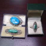A silver and marcasite set ring and brooch, and a turquoise and silver brooch (3)