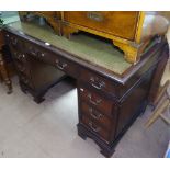 A reproduction mahogany twin-pedestal writing desk