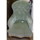 A Victorian iron-framed button-back upholstered armchair