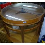 A mid-century circular teak nest of tables, with glass top, and 3 further oval occasional tables