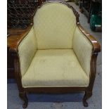 An Edwardian upholstered and carved oak-framed Club chair